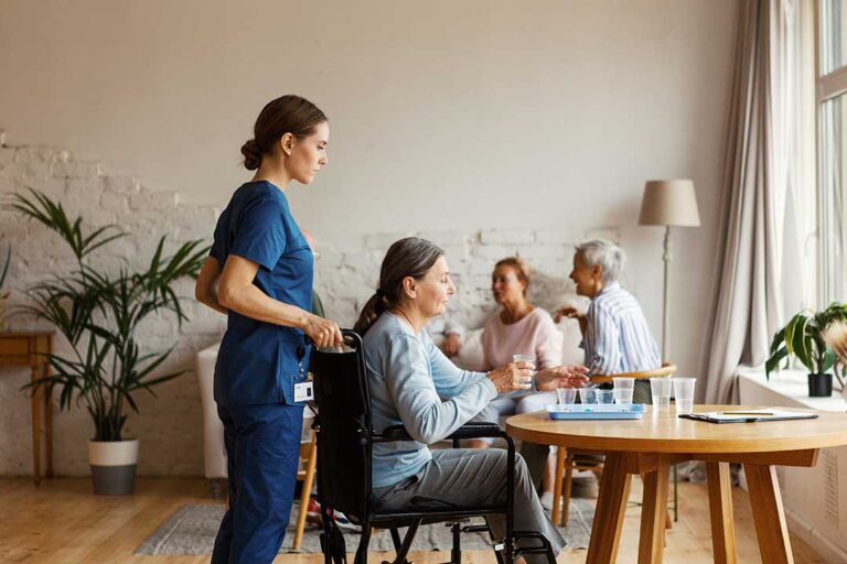 Older adults and family members review a care assessment at a kitchen table with notes and a calendar.
